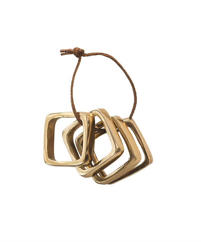 square metal napkin rings on leather tie in brass finish design by bd edition 1